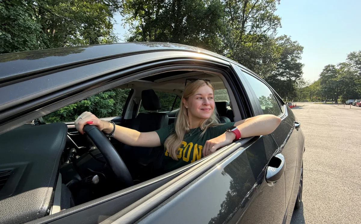 A student driving her vehicle around the campus